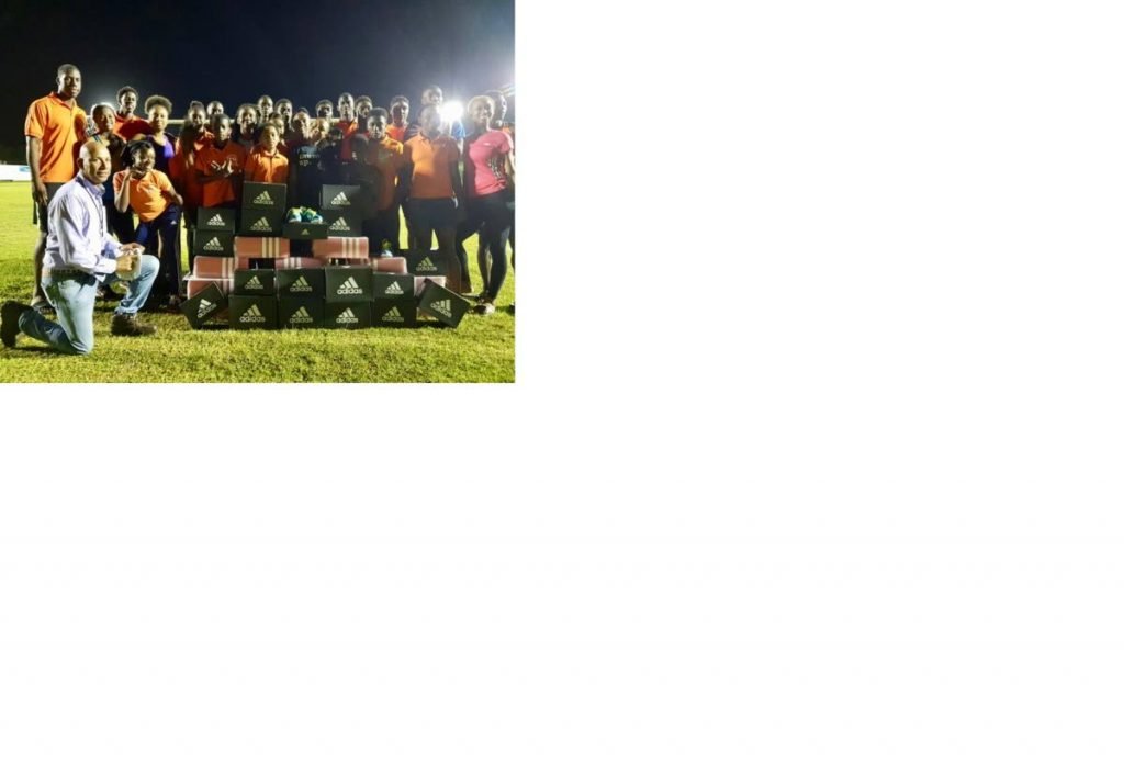 Coaches and athletes at Point Fortin New Jets pose with adidas footwear donated by national track star and Point Fortin native Jereem Richards.
