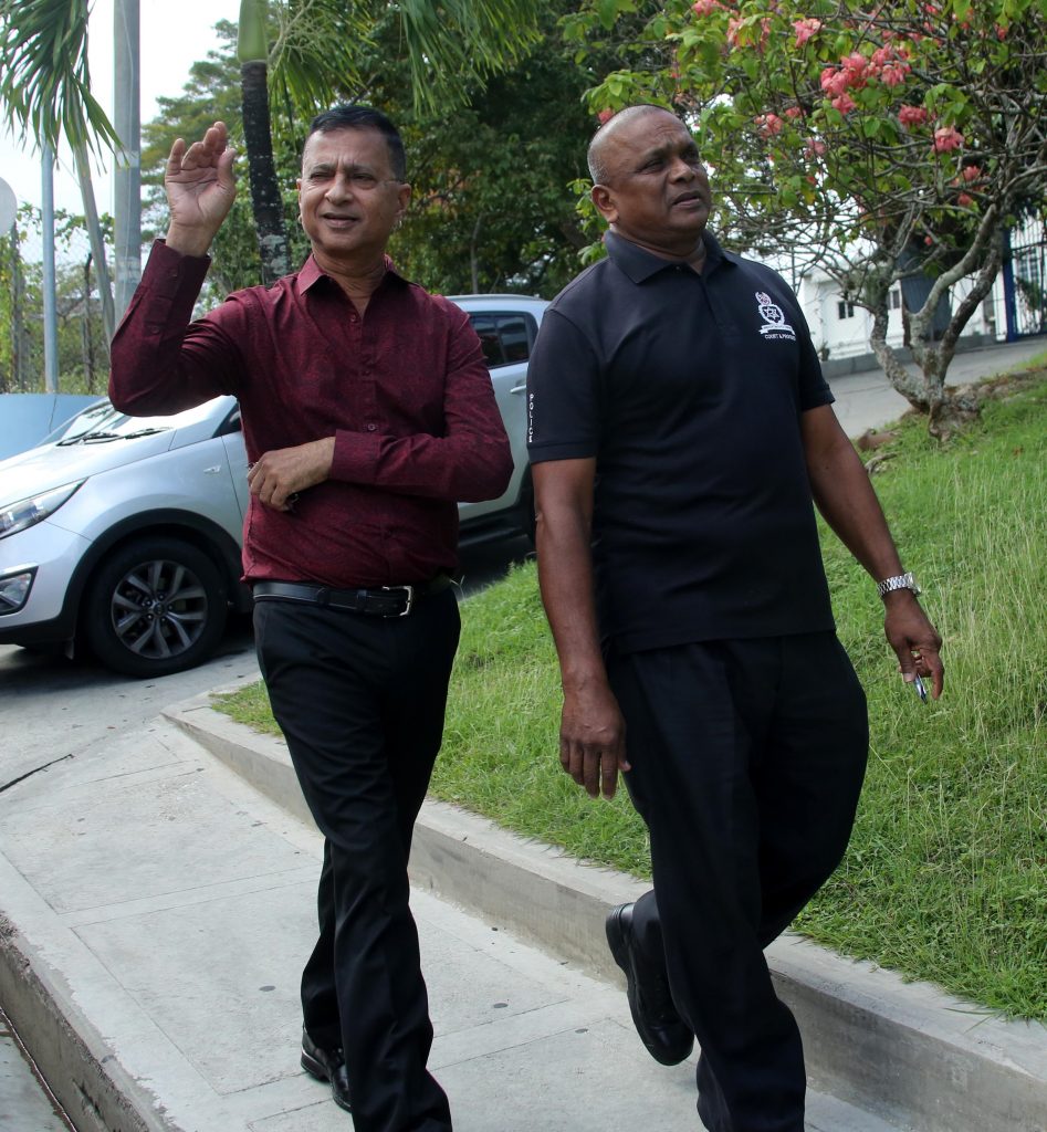 
OFF TO COURT: Businessman Hanif Baksh waves to onlookers as he made his way to the San Fernando Magistrates Court yesterday. PHOTO BY VASHTI SINGH