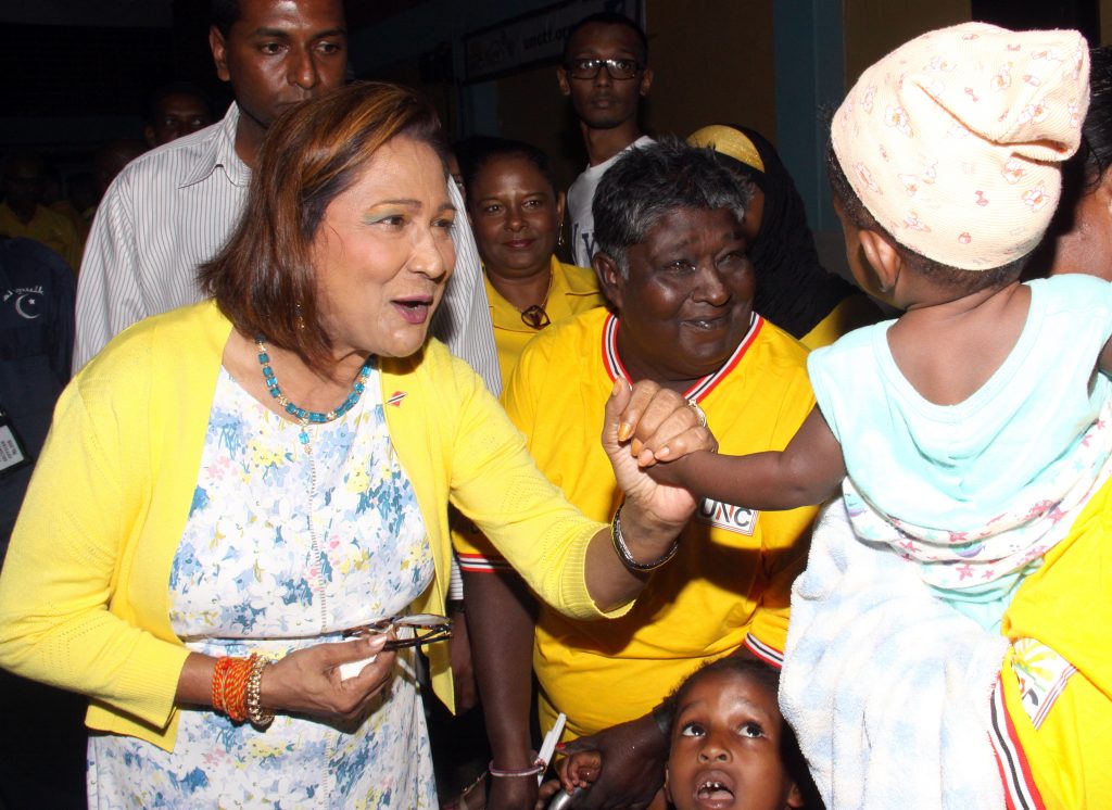 TELL MAMMY VOTE FOR ME: Opposition Leader Kamla Persad-Bissessar plays with a baby as she arrived at the UNC’s Monday Night Forum at the St Joseph Secondary School. 
PHOTO BY ANGELO MARCELLE