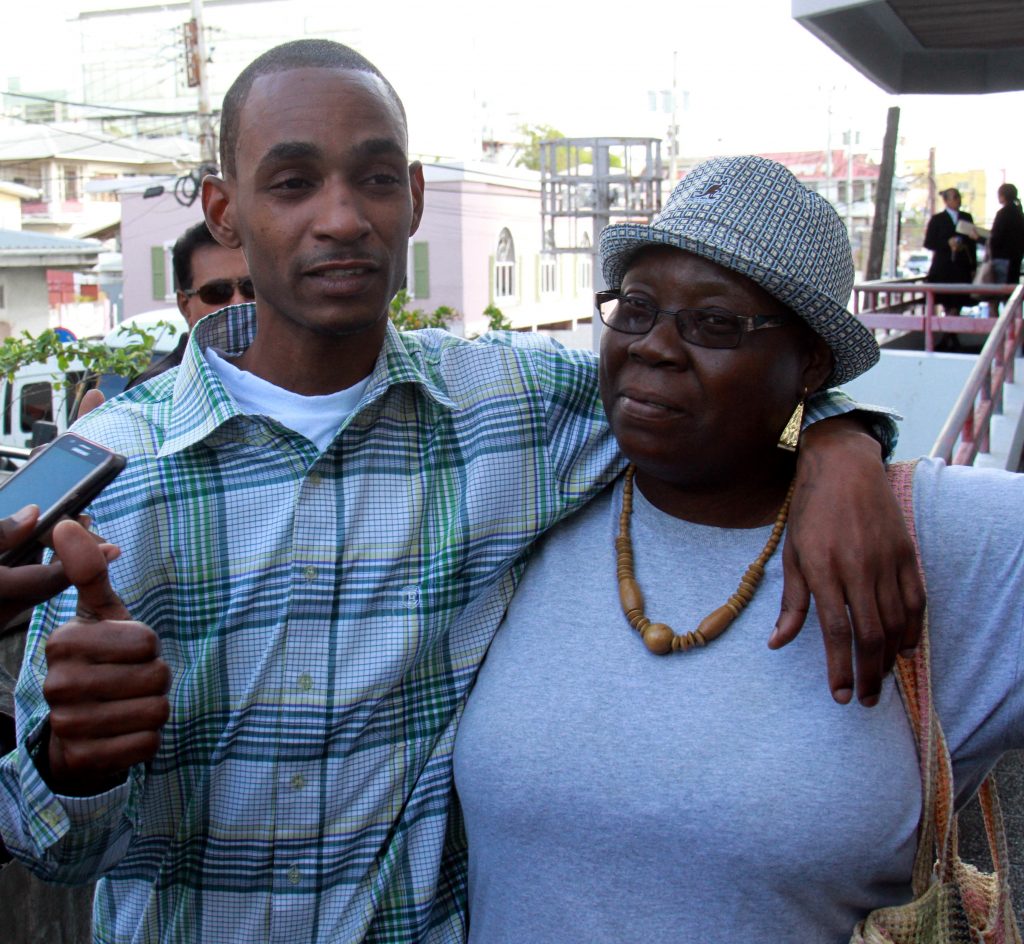 I’M FREE: Jimmy Huggins with his mother Erica Saunders outside the San Fernando High Court after he was freed of murder yesterday. PHOTO BY ANIL RAMPERSAD

