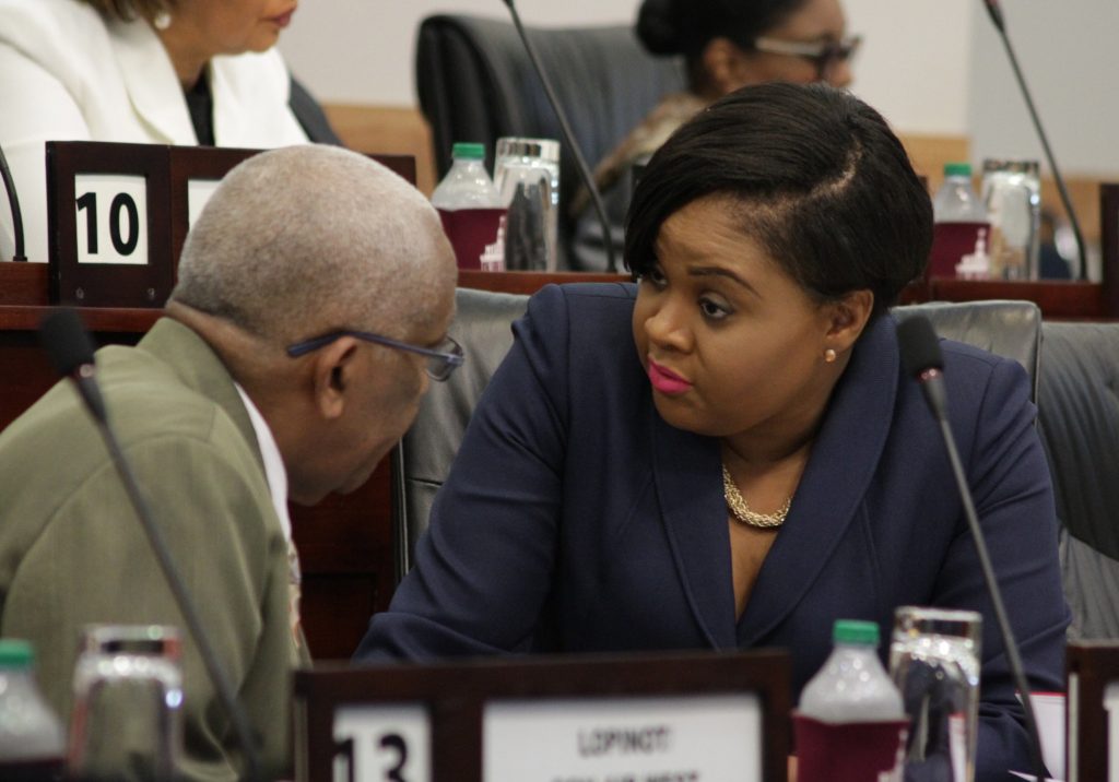 SAY WHAT: Tourism Minister Shamfa Cudjoe wears a quizzical look as she speaks with Education Minister Anthony Garcia yesterday in Parliament. PHOTO BY ROGER JACOB