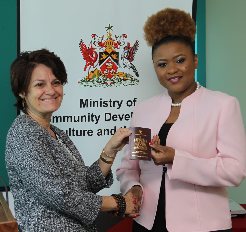 Lorraine O’Connor (left) receives the diplomatic passport on behalf of Calypso Rose from Culture Minister Dr Nyan Gadsby-Dolly.