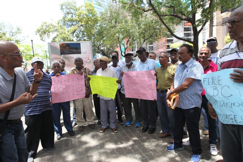 WE ARE OWED: Retired TSTT workers protest outside the company’s Edward Street, Port of Spain office yesterday. PHOTO BY RATTAN JADOO
