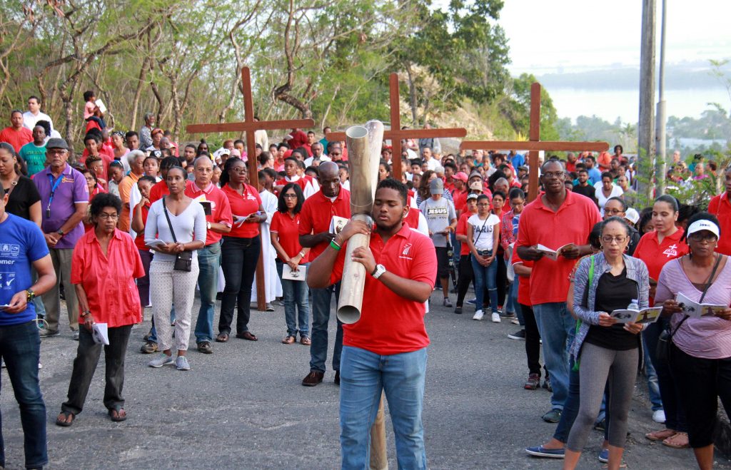 Parishioners carry replicas of the Cross during the Good Friday procession at San Fernando Hill, yesterday. PHOTO BY ANIL RAMPERSAD