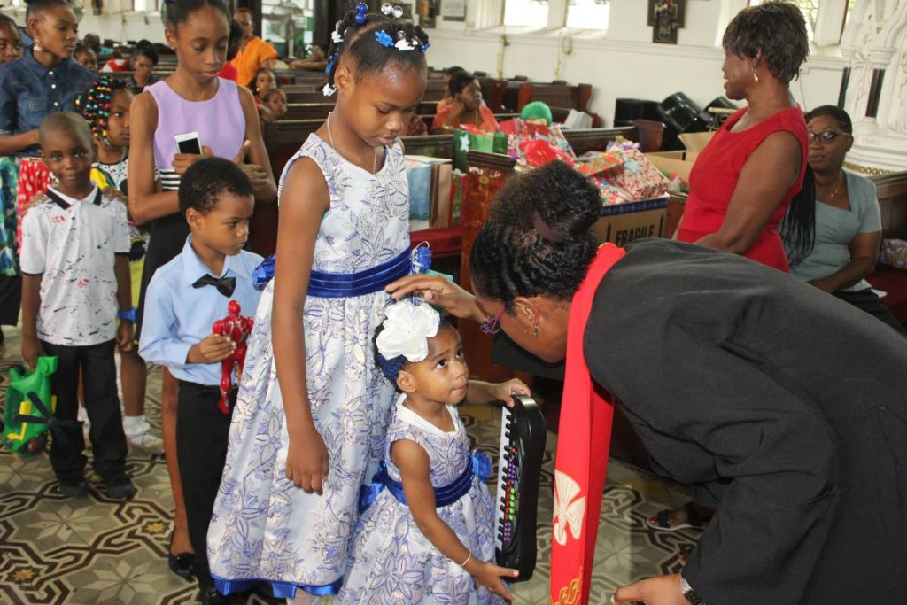 Blessed are the children: Anglican priest Shelley Ann Tenia blesses children and their toys at the Feast of the Holy Innocents service, Holy Trinity Cathedral, Port of Spain on December 28, 2017. File photo