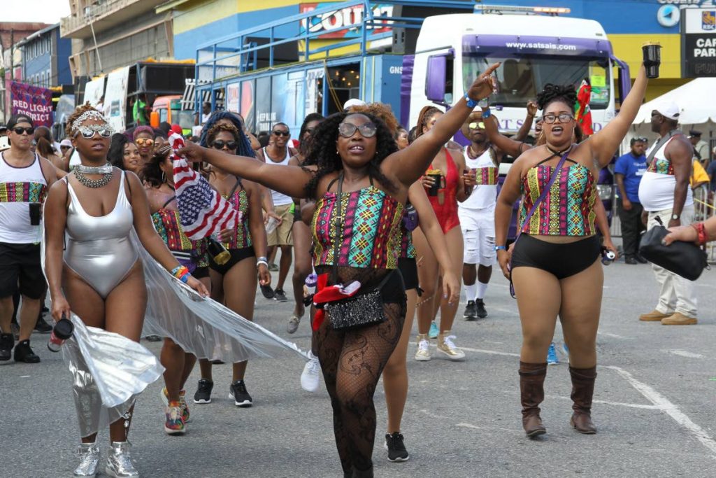 Masqueraders move through the streets on Carnival Monday. 