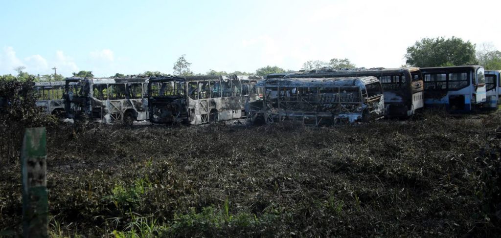 BURNT: The PTSC buses which were burnt during a bush fire on Monday in Carlsen Field, Chase Village. PHOTO BY VASHTI SINGH
