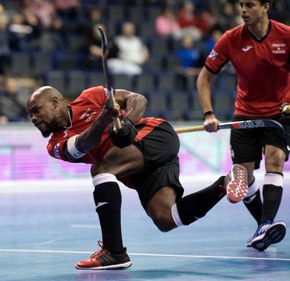 Trinidad and Tobago captain Solomon Eccles, left, takes a shot at goal against Poland during the recent Indoor Hockey World Cup in Germany.