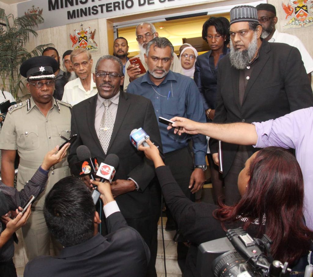 SATISFIED: National Security Minister Edmund Dillon speaks with reporters after a meeting with leaders of the Muslim community at his ministry yesterday.  Also at the meeting were Ag Commissioner of Police Stephen Williams and Attorney General Faris Al-Rawi.