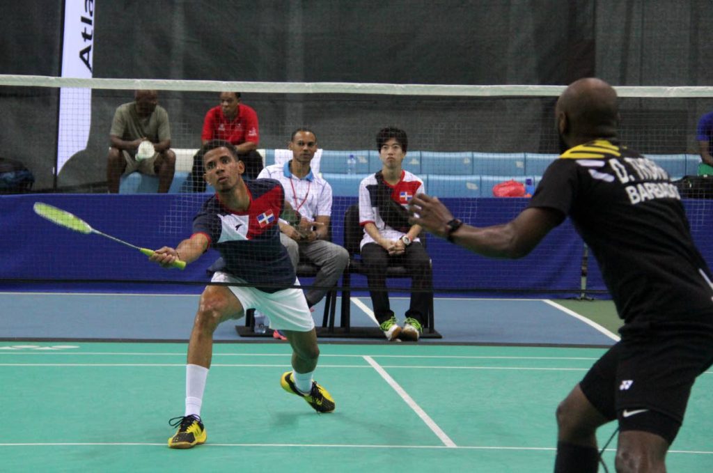 Reymi Cabreras of Dominican Republic, left, and Dakeil Thorpe of Barbados battle in a singles match at the National Racquet Centre in Tacarigua, yesterday.