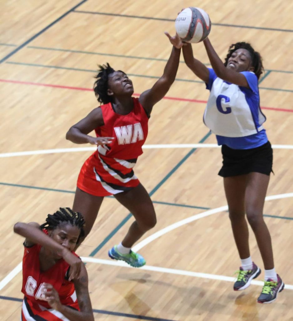 UTT’s Faith Hagley, left, and UWI’s Canice Jacobs vie for the ball in a recent Courts All Sectors Netball League match at the Maloney Indoor Facility, Maloney.
