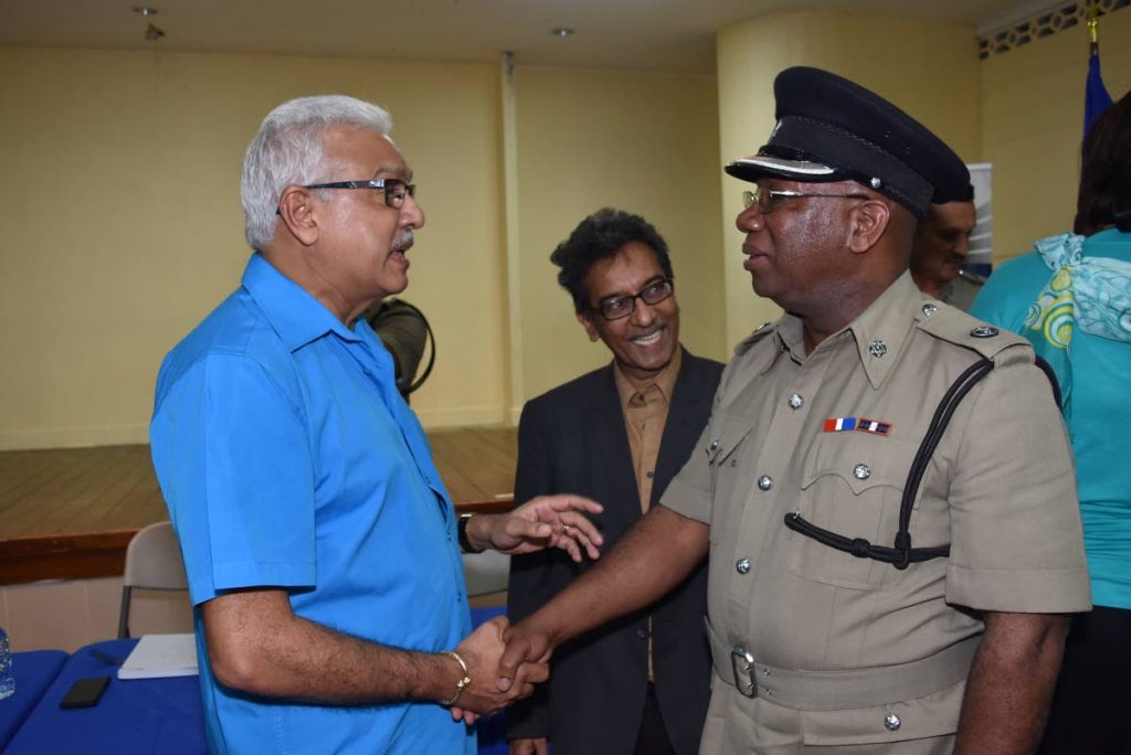 SECURE SHAKE: St Joseph MP Terrence Deyalsingh (left) shakes hands with ACP McDonald Jacob following a police town meeting held at the St Joseph Community Centre. Looking on is Dr Varma Deyalsingh.