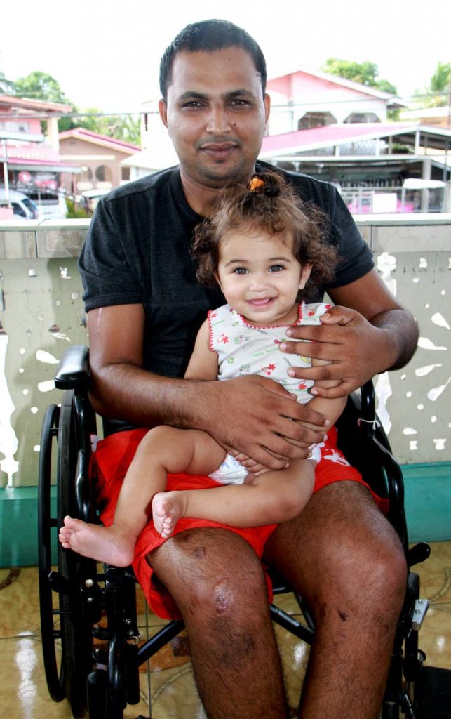 SEEKING JUSTICE: Shameer Boban with his daugher Karen, eight months, at their Barrackpore home yesterday.