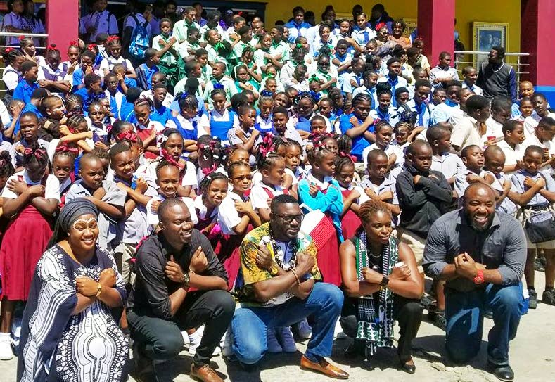 ON DUKE: THA Minority Leader Watson Duke, kneeling centre, poses with students from 10 schools from Tobago East who were taken to view the movie Black Panther in Tobago today. Tickets for the hundreds of children were bought by the Minority Council in conjunction with Duke and his family.