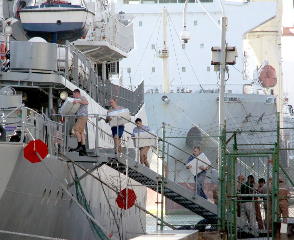 The crew of the Viktor Leonov, a Russian ship, carries supplies on board the vessel docked at the Port of Spain International Waterfront on Friday.