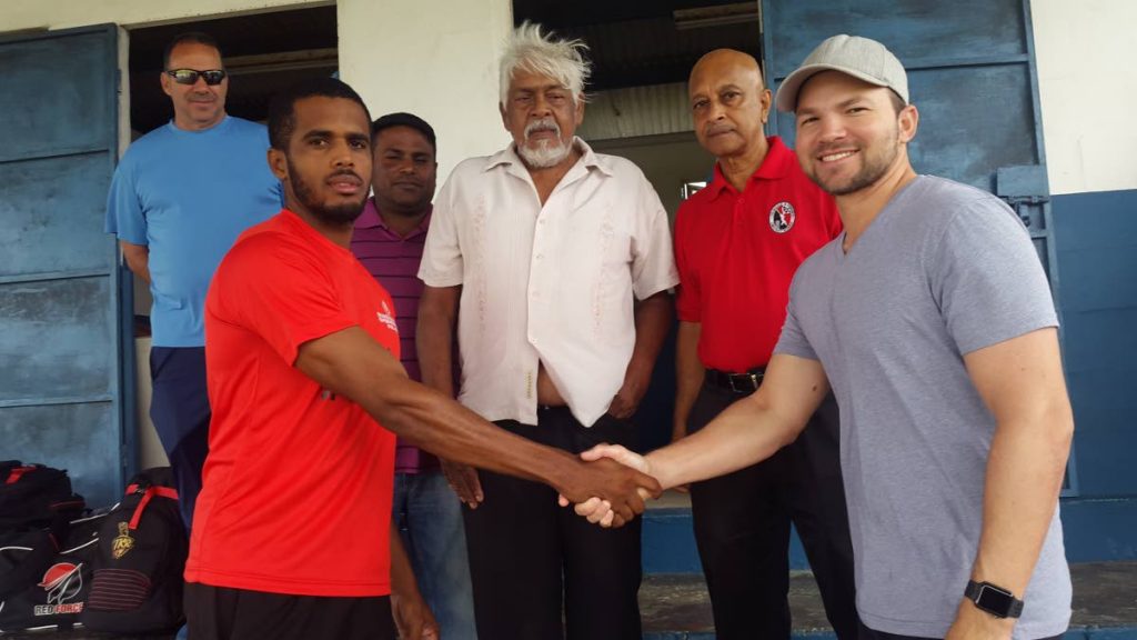 Queen’s Park captain Justin Guillen, right, and his Central Sports counterpart Kjorn Ottley, shake hands before their clubs clashed in the opening match of the Premier I cricket competition yesterday at Invaders Ground in Felicity. From left are Parkites manager Jeffrey Guillen, Ryerson Bhagoo of the National League, second vice-president of the TTCB Lalman Kowlessar and Dudnath Ramkessoon, chairman of the National League.