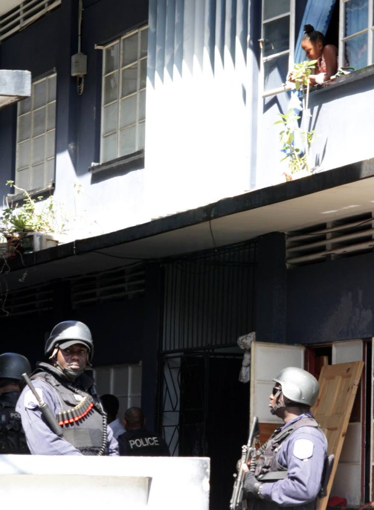 Member of the T&T Police Service, Guard and Emergency and Defence Force conduct an operation in the housing complex along upper Nelson Street. PHOTO BY ROGER JACOB.