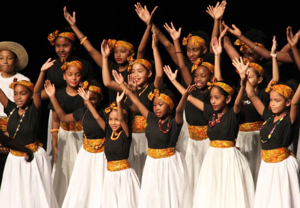 MAKE A JOYFUL NOISE: The Holistic Folk Song choir performs in the Primary School Folk Song 
segment yesterday at the 32nd biennial Music Festival at Queen’s Hall. PHOTO BY SUREASH CHOLAI