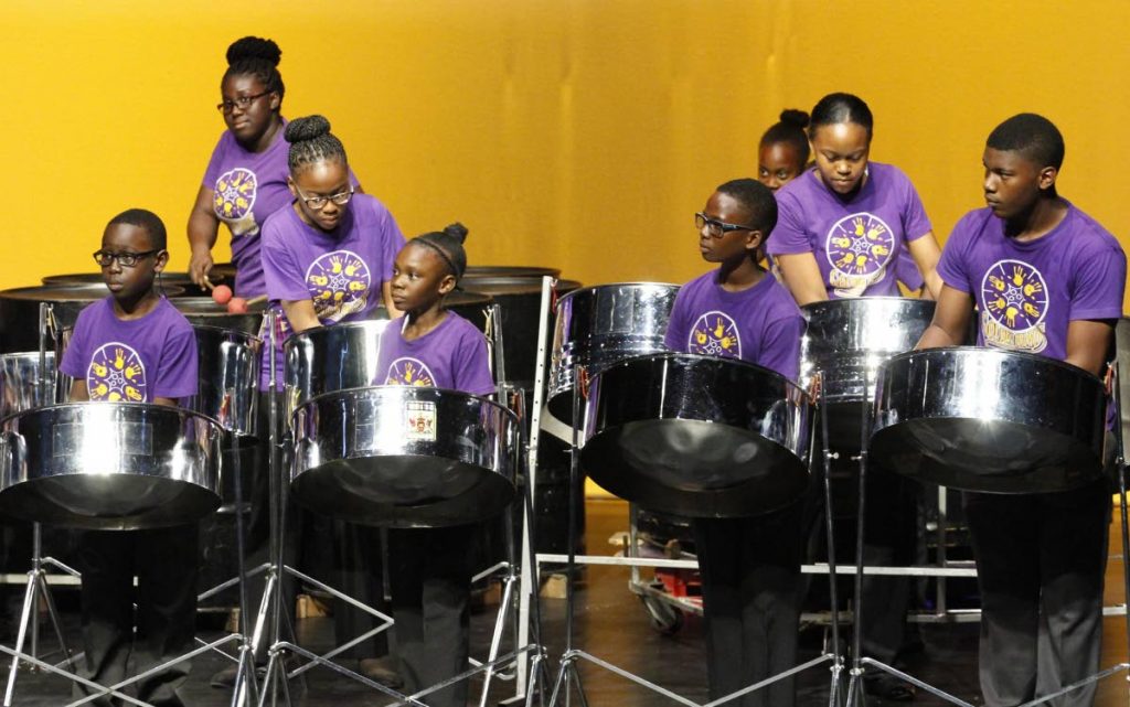 Members of the Golden Hands Junior Ensemble perform their winning piece You Raised Me Up at the 32 biennial Music Festival at Naparima Bowl, San Fernando on Tuesday.