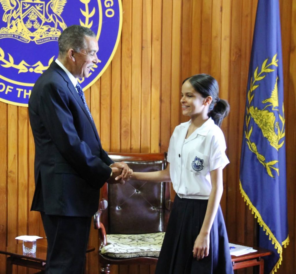 NICE TO SEE YOU AGAIN: President Anthony Carmona (left) greets Caitlin Brooker, the top performing SEA student for 2016 and current Naparima Girls' High School student, at President's House, Port of Spain yesterday. 