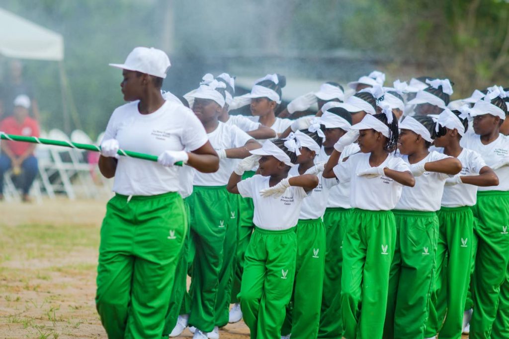 WINNING PERFORMANCE: Guapo Government Primary’s march past team on their way to victory in the La Brea Zonal Primary School Games yesterday at Sobo Recreation Ground, La Brea.