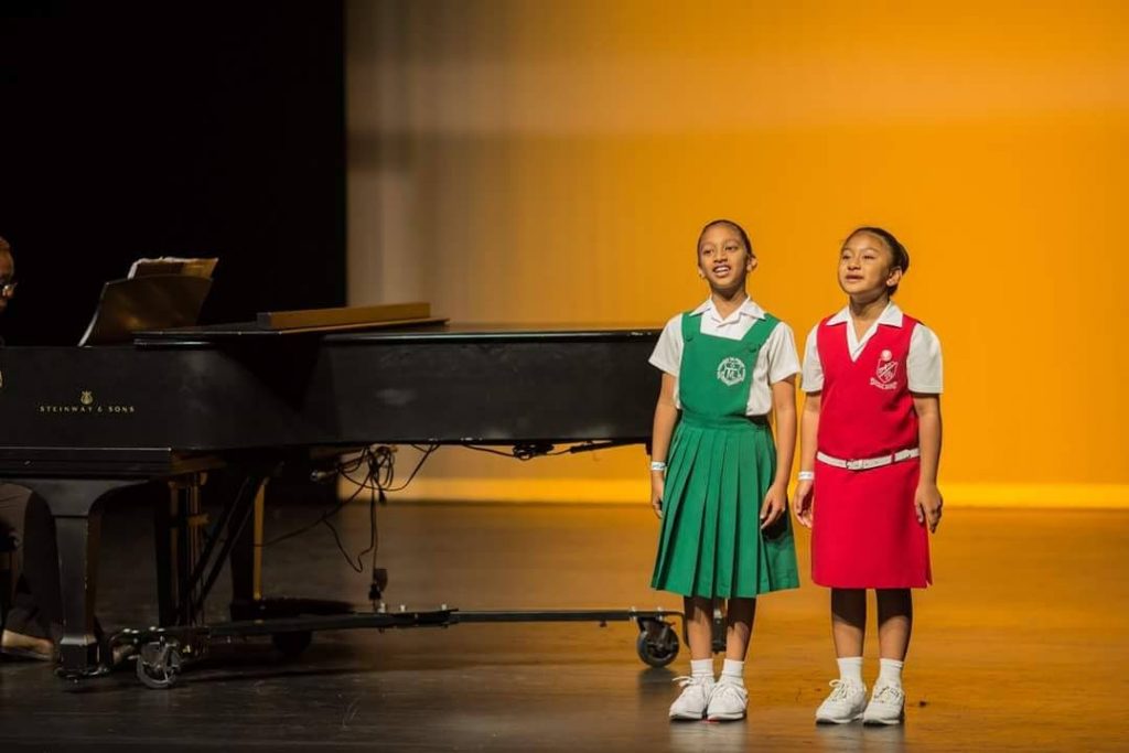 Our song: Saheli Ali, left, of TML Primary School, and Taylor Lee of Cedar Grove Private School perform in the Girls Vocal Duet (12 years and under) at Naparima Bowl, San Fernando on Friday. The tied for third place with the duet of Mackenzie Roberts and Arianna Reefer.