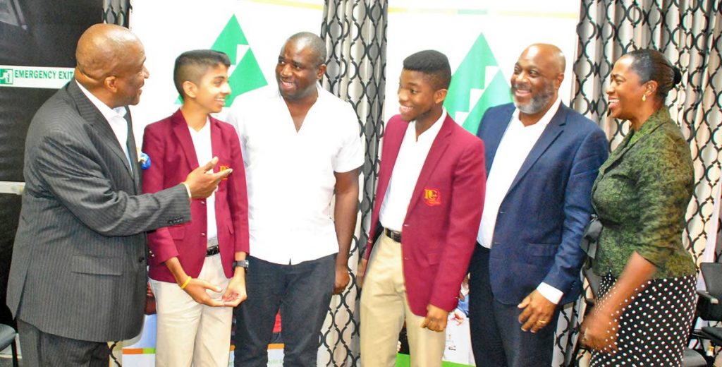 J. Errol Lewis, Executive Director, Junior Achievement of Trinidad and Tobago, captures the attention of (from left to right) Kabir Singh, Presentation College student; UK MP David Lammy; Jerod Griffith, Presentation College student; JA Chairman Anthony Pierre; and JA Director Dawn Richards. The occasion was a familiarisation visit to JAOTT by Lammy.

