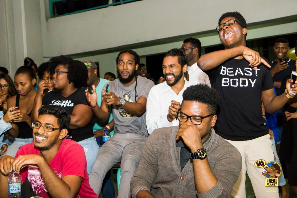 The audience gets the joke at Nah Hoss That Real Funny. Seated at centre in white shirt is Darrion Narine, a spoken word performer and the vice president of the UWI Students’ Guild. He helped Caricomedy stage the show at the campus. 

