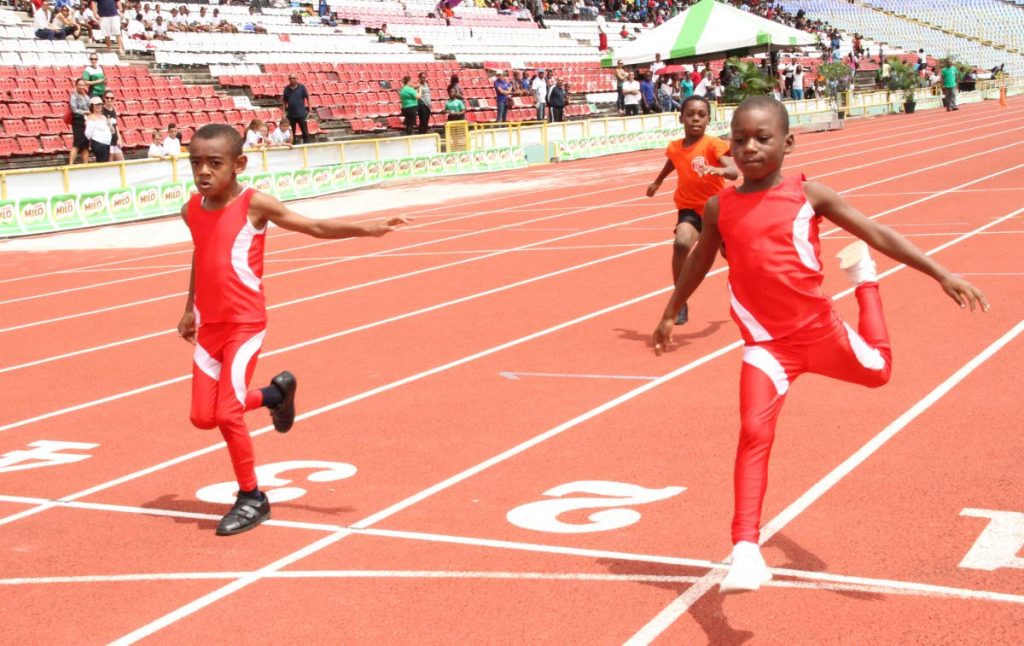 Hasheen Salandy,right, of tDiamond Vale Government Primary School finishes in first place ahead of schoolmate Ajani SPEEDSTER: Taylor,left, in the Boys U-7 50 metres race at the 31st MILO Games at the Hasely Crawford Stadium, Mucurapo yesterday.