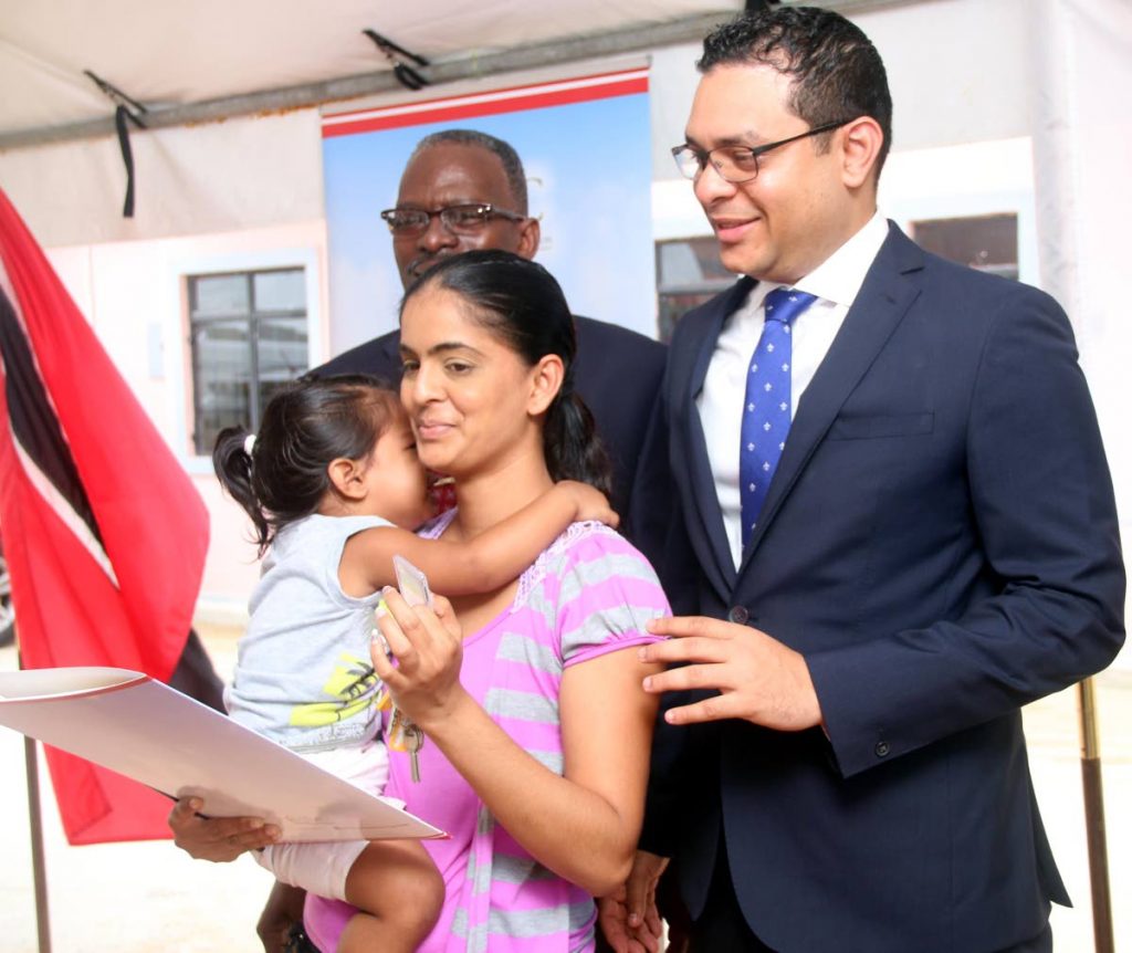 HAPPY TIMES: Candice Ganness and her son Keegan received keys to their new HDC home by Housing Minister Randall Mitchell yesterday, a week after Ganness and other residents of Cedros lost their homes to coastal erosion. PHOTO BY ANSEL JEBODH