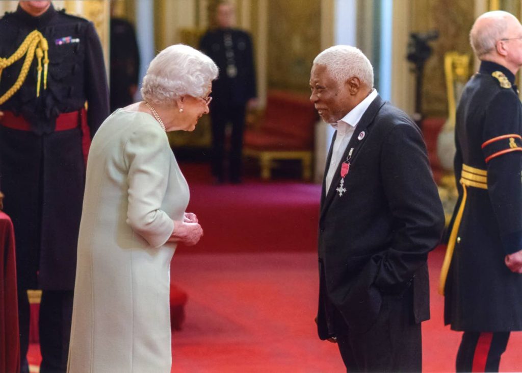 Leslie Palmer with Queen Elizabeth II at Buckingham Palace for his Member of the British Empire award.