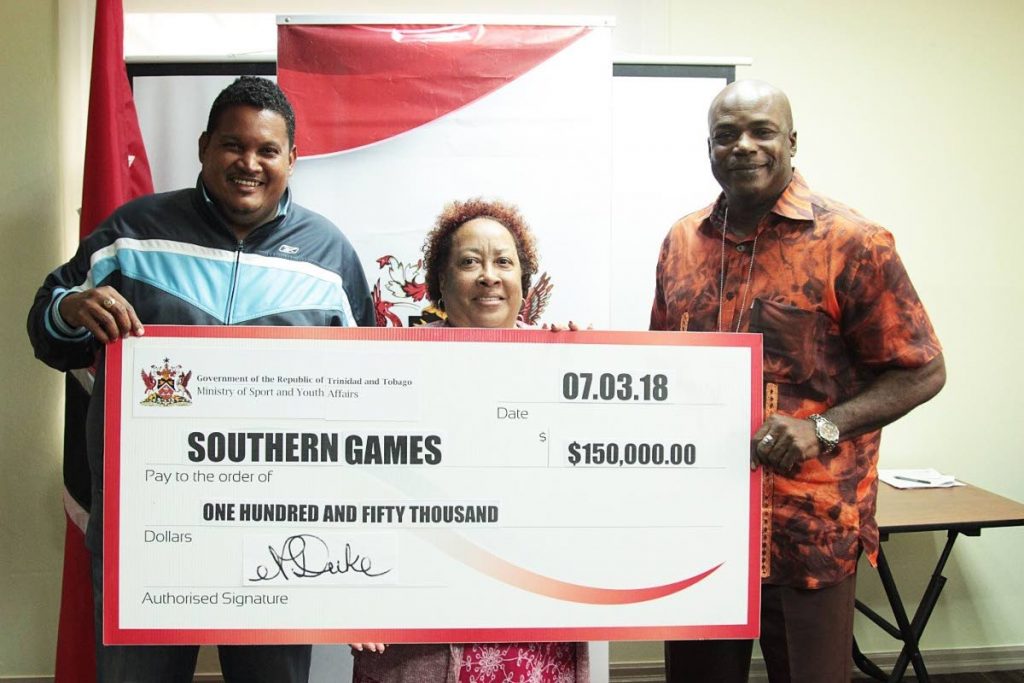 Darryl Smith (left), Minister of Sport and Youth Affairs, Carol Grandison (centre), Southern Games Event 
Coordinator and Hasely Crawford, Olympic Gold Medalist, at a cheque presentation ceremony at the
Ministry’s Head Office, St Clair on Wednesday. PHOTO COURTESY MINISTRY OF SPORT AND YOUTH AFFAIRS
