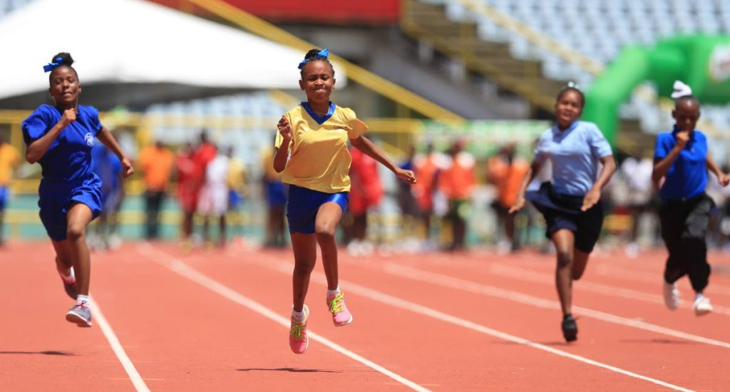 Kerlis Navarro (second from left) of Success RC School speeds to victory in the Girls Under-13 East Zone ‘A’ 100-metre race yesterday.