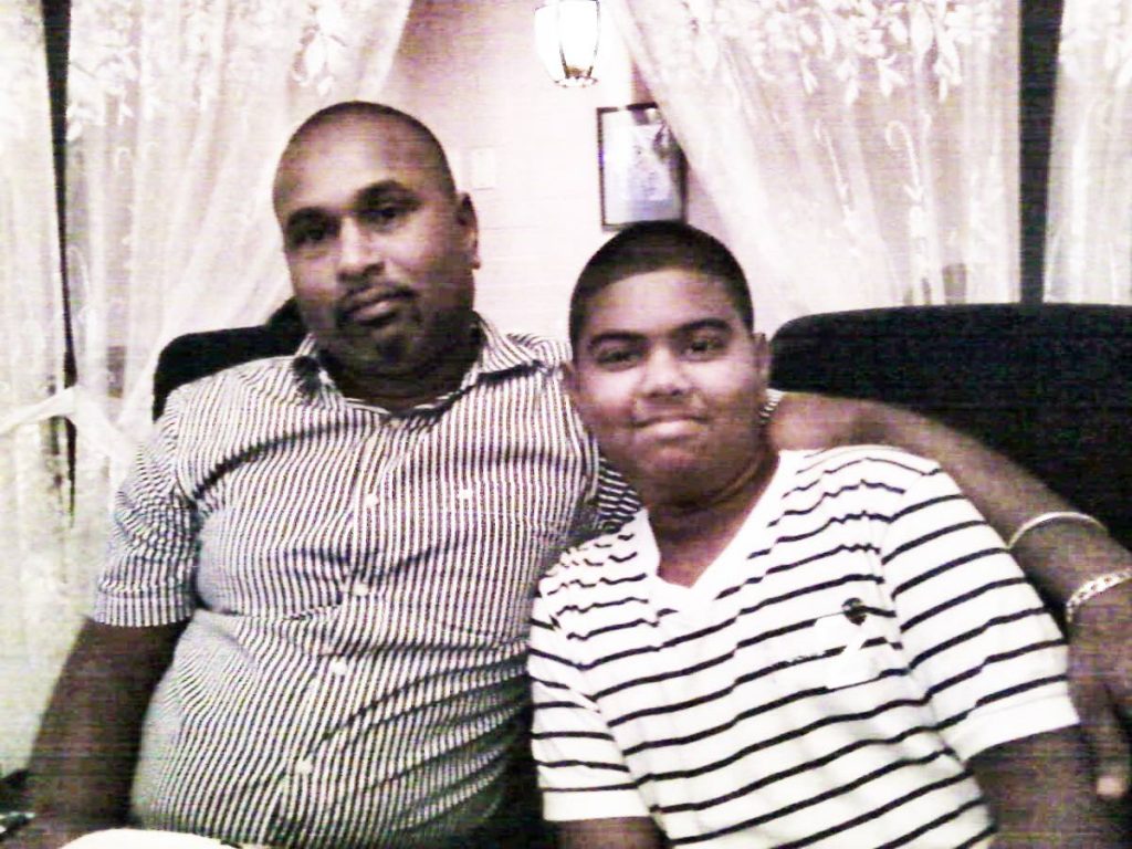 ME AND MY SON: Shakar Beephan is seen in this photo with his son Jesse who almost a year ago, was found murdered at the back of the Waterloo High School. To date, his killer remains at large.