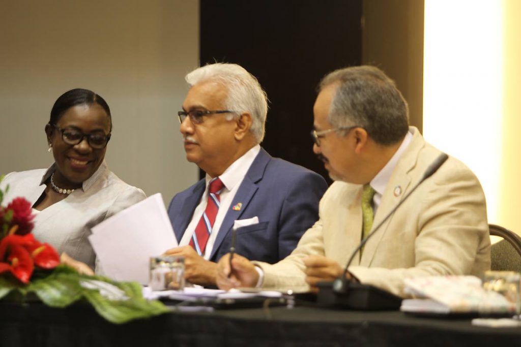 Frome left, Guyana's Education Minister Nicolette Henry, TT Minister of Helthe Terrence Deyalsingh and UNAIDS Director DR. Cesar Nunez converse during the 6th meeting of the national AIDs programme at the Hyatt Regency. Photo: Rattan Jadoo