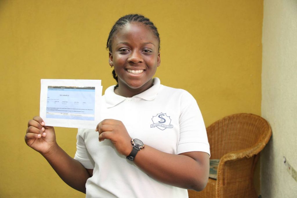 A grade: Keziah John proudly displays her CSEC exam results for mathematics. She received As in each category. 