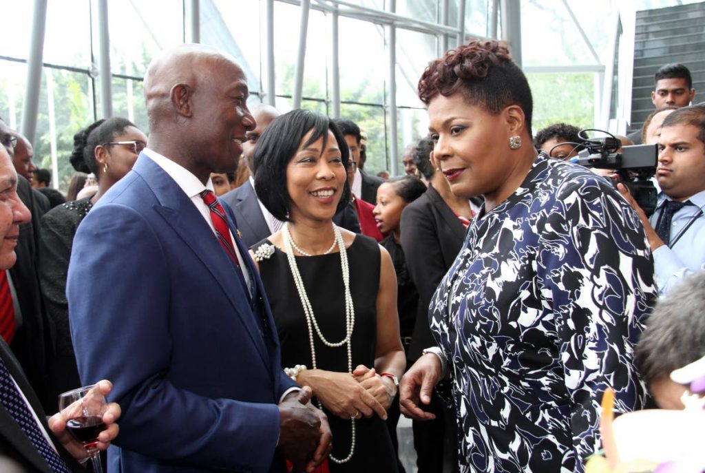 Prime Minister Dr Keith Rowley speaks with President Paula-Mae Weekes yesterday at NAPA in Port of Spain. At centre is Rowley’s wife Sharon. PHOTO BY SUREASH CHOLAI