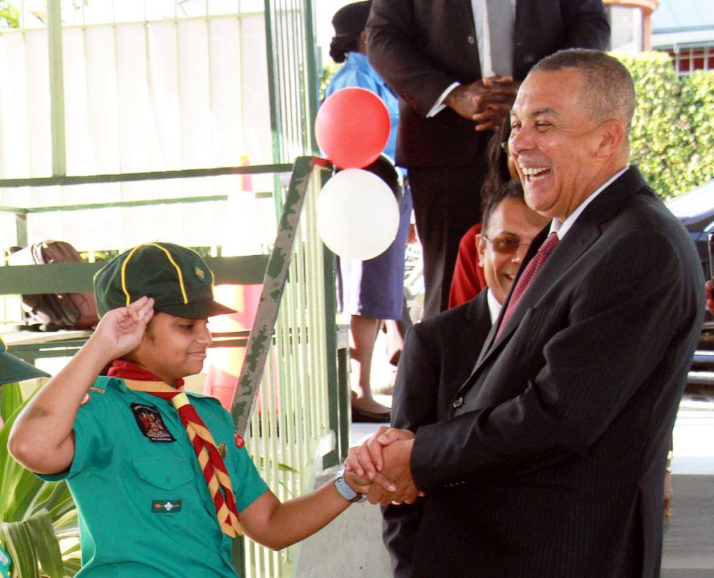 Former President Anthony Carmona interacts with a boy scout at the Cedar Grove Primary School in Palmiste, South Trinidad. PHOTO BY ANIL RAMPERSAD