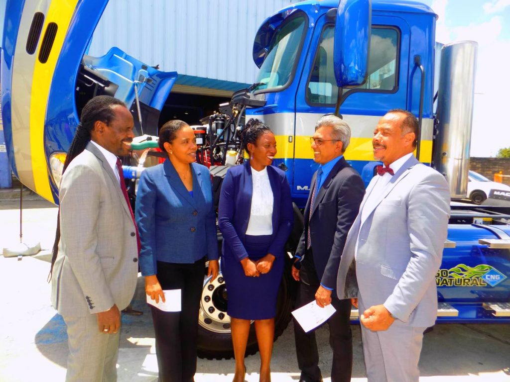 Minister in the Office of the Attorney General Fitzgerald Hinds, left, Permanant Secreatary in the Ministry of Works and Transport Sonia Francis-Yearwood, VMCOTT CEO Natasha Prince, President of the NGC CNC Co Ltd Curtis Mohammed and VMCOTT Chairman Lt Col Neil Bennett speak in front a CNC truck at the rebranding ceremony of VMCOTT at the corporation's Beetham compound yesterday.