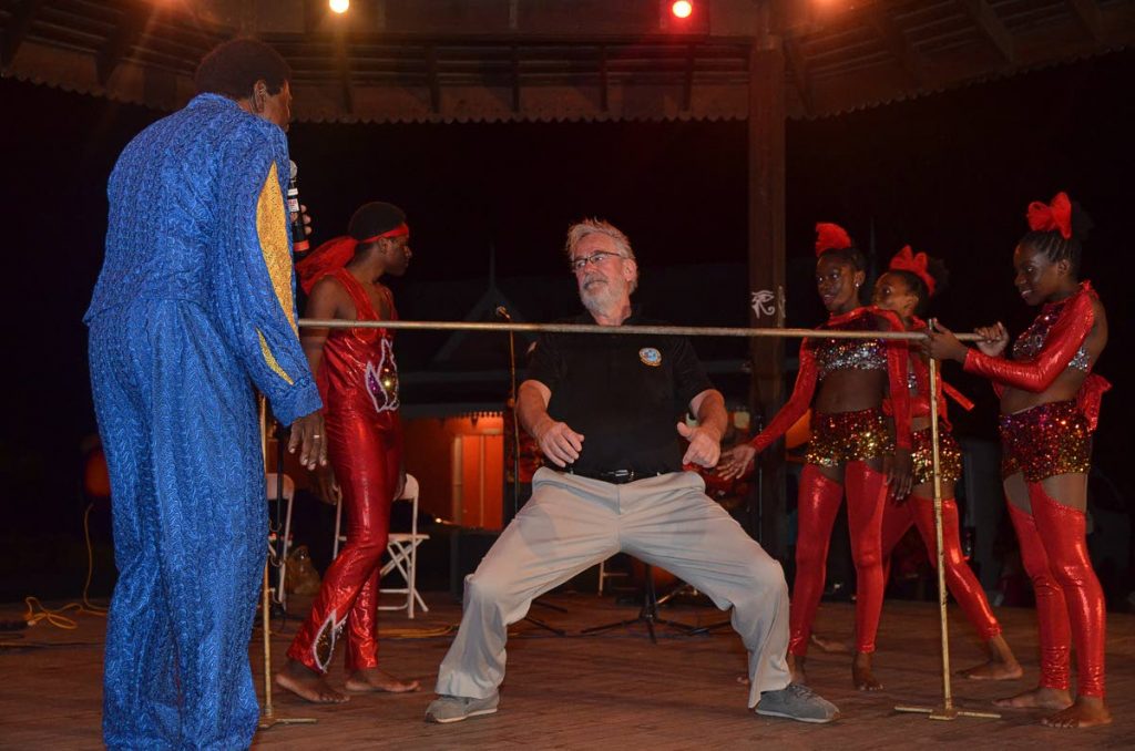 A participant in the Governor Generals Cup (GGC) Caribbean Air Rally enjoy the limbo at a reception hosted by the Division of Tourism at the Pembroke Heritage Park last Friday. 