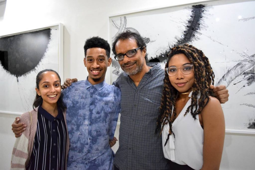 Christopher Cozier, second from right, with well-wishers at the opening of his exhibition at Y Art Gallery on March 19.