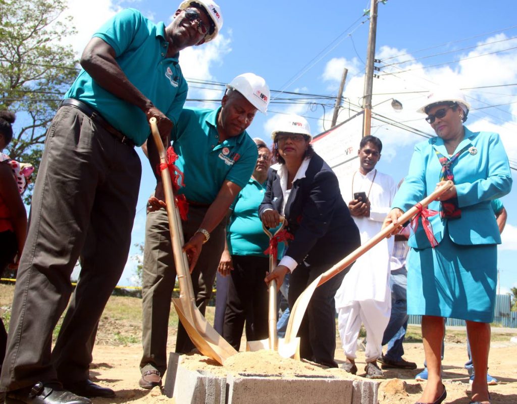 Clarance Mendoza, left, chairman of the Land and Building committee of the National Parent Teachers Association (NPTA) along with Walter Stewart, second from left, NPTA President Raffiena Ali-Boodoosingh, centre, and Zena Ramathali, former NPTA president turn the sod for the construction of the new NPTA Headquaters in Chaguanas.