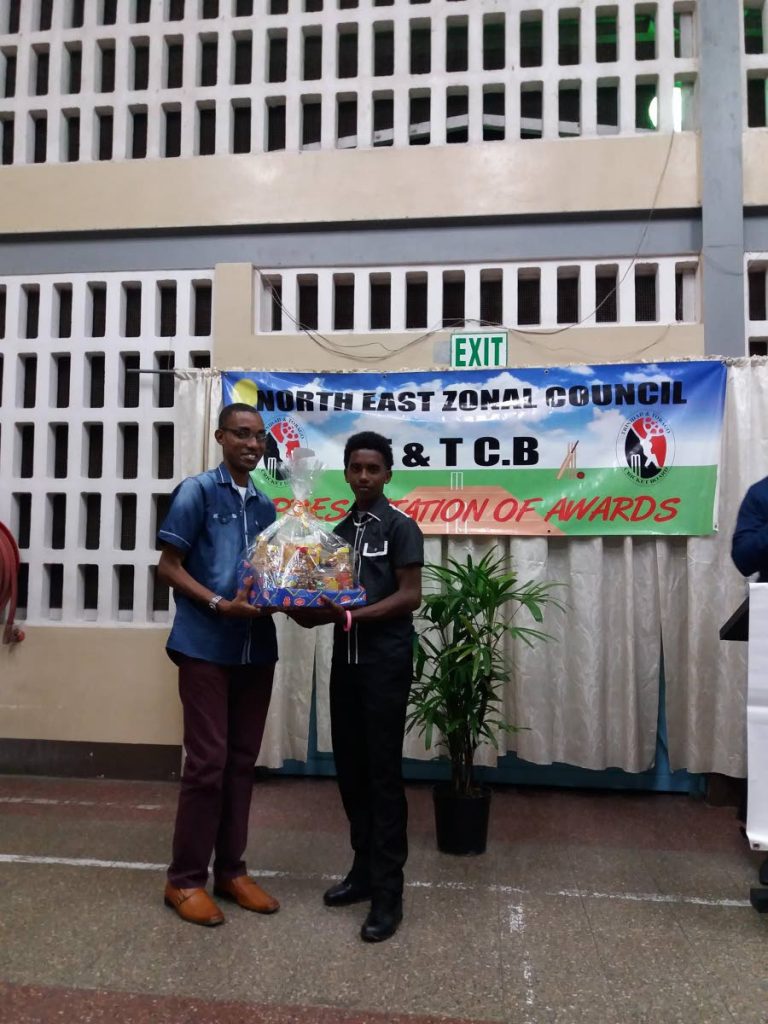 Anderson Mahase, right, receives the youth cricketer of the year award.
