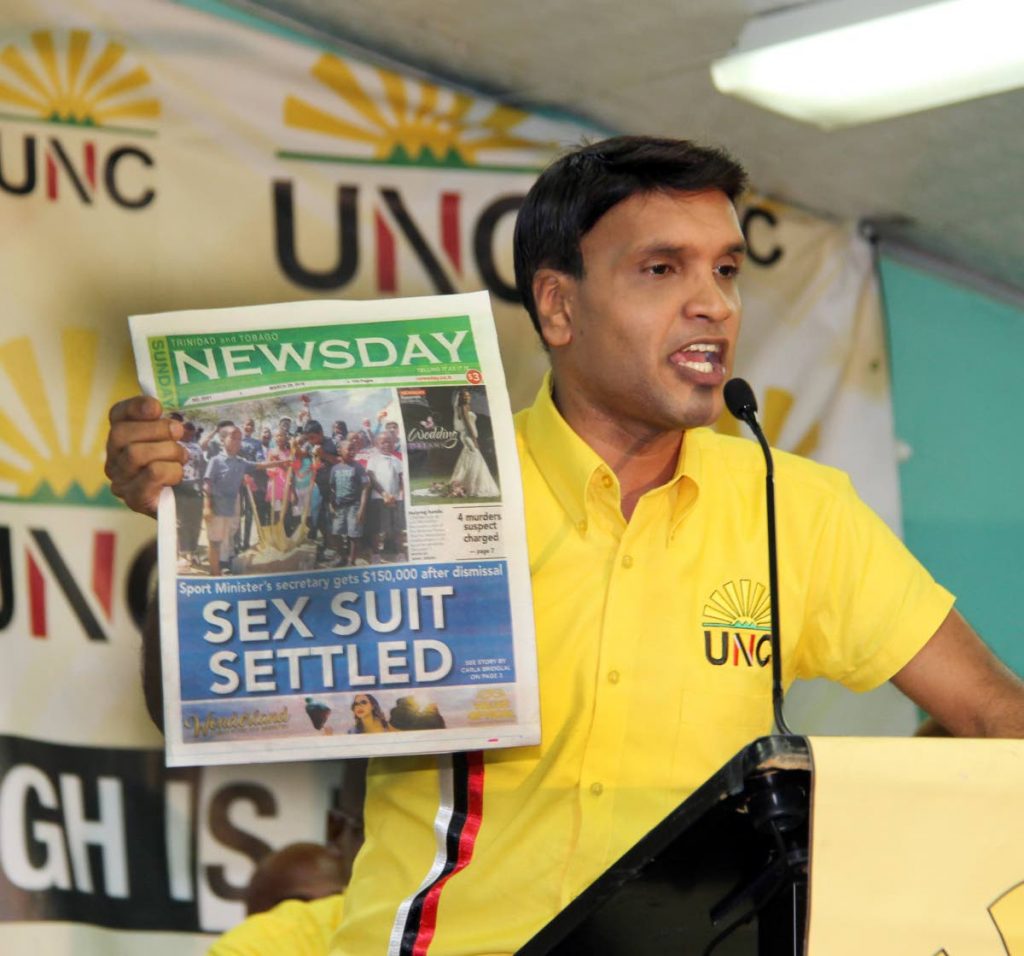ANSWER THIS: Princes Town MP Barry Padarath holds a copy of last Sunday's Newsday, asking for clarification on the lead story at the UNC's Monday Night Forum at the Las Lomas #2 Primary School.  PHOTO BY SUREASH CHOLAI