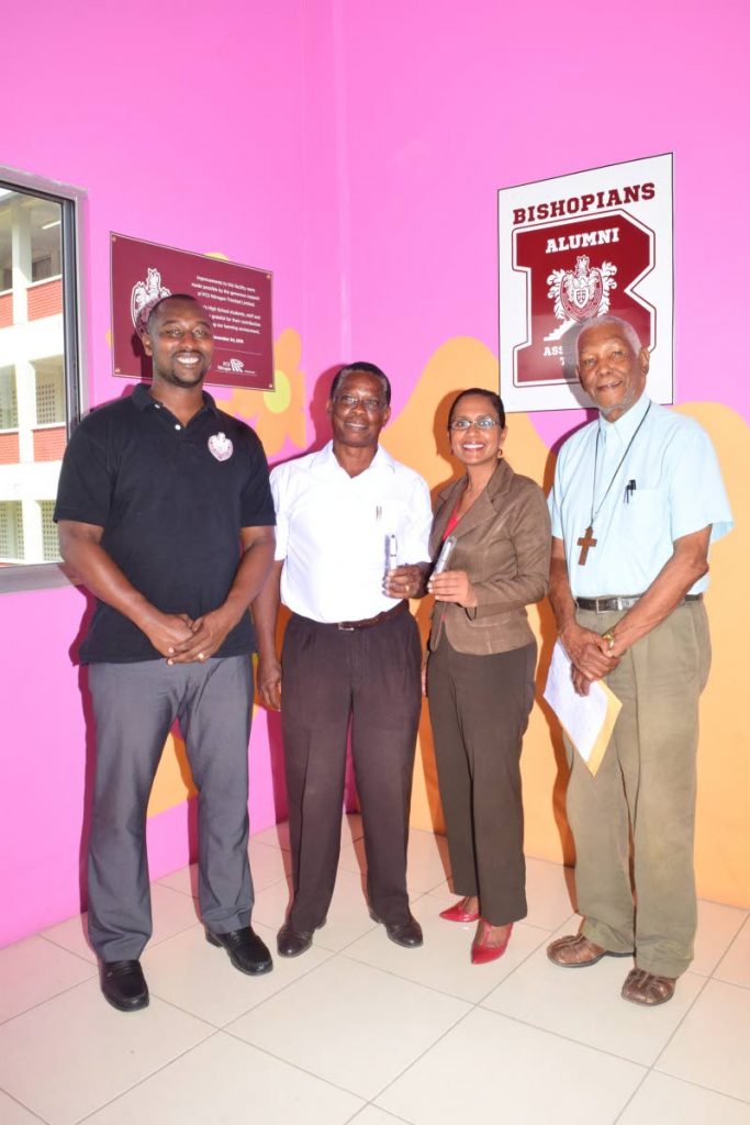 From left, football coach Richard Goddard, Project Chairman for the Bishops High School new sport field - Dr Alison Williams, Acting Principal Cindy Ramnarine and Chairman of the Board of Governors of the school, Archdeacon Kenneth Forrester, display pen drives that are on sale to help raise funds for the schools $4 million sports ground. 