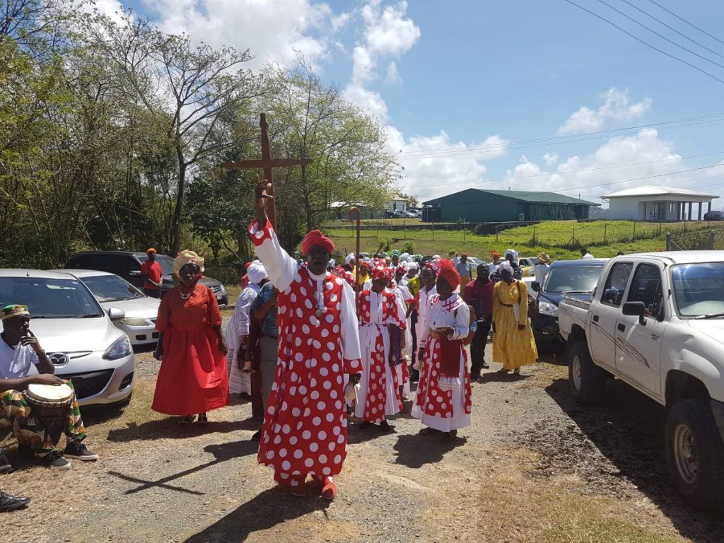 Bishop Mural Dillon, President of the Tobago United Spiritual Baptist Assembly, leads the procession of members along the Claude Noel Highway to the venue for the celebrations at the Assemblys land at Signal Hill last year. 