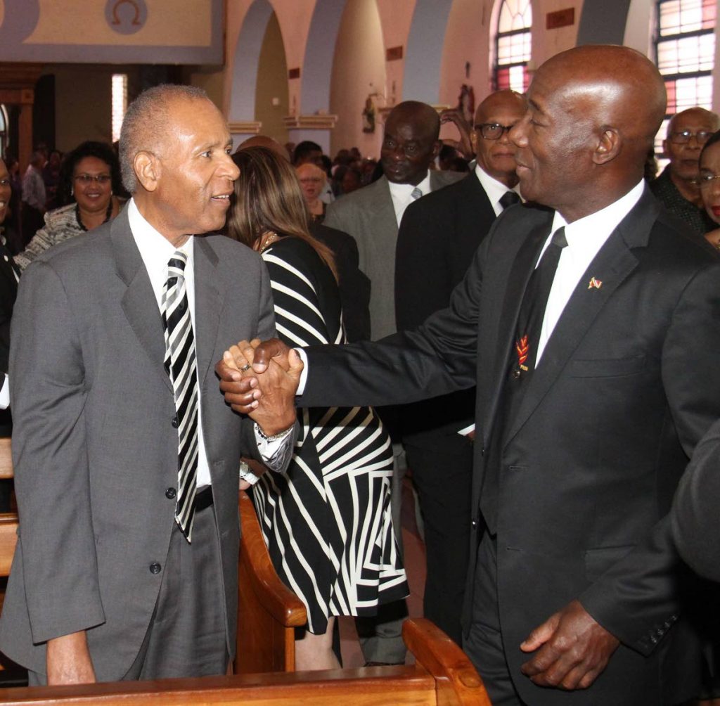 MY BROTHER: Prime Minister Dr Keith Rowley, right, warmly greets former prime minister Patrick Manning in February 2016, as they attended the funeral of PNMite Winston Moore. Five months later, Manning would die after at San Fernando General Hospital. FILE PHOTO