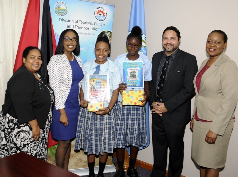 First place winner in the Tourism and Respect for IP (Intellectual Property) secondary school competition, Angel Melville, third from left, and second place winner, Shaquaner Williams, fourth from left, pose for a photo with, from left, Deputy Controller of Intellectual Property, Anne Marie Omed-Joseph; Tourism Secretary Nadine Stewart-Phillips; Controller of Intellectual Property,  Regan Argardli; and Tourism Division’s Administrator Claire Davidson-Williams following the prize giving event on April 17 at the Division of Tourism.