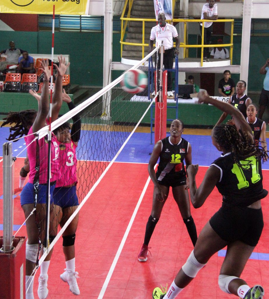 Glamorgan’s Shushanna Marshall, right, strikes the ball as West Side Stars’ Malika Davidson and Amber Commissiong defend in the Flow Volleyball League final yesterday at the Jean Pierre Complex, Mucurapo. PHOTO BY ROGER JACPB