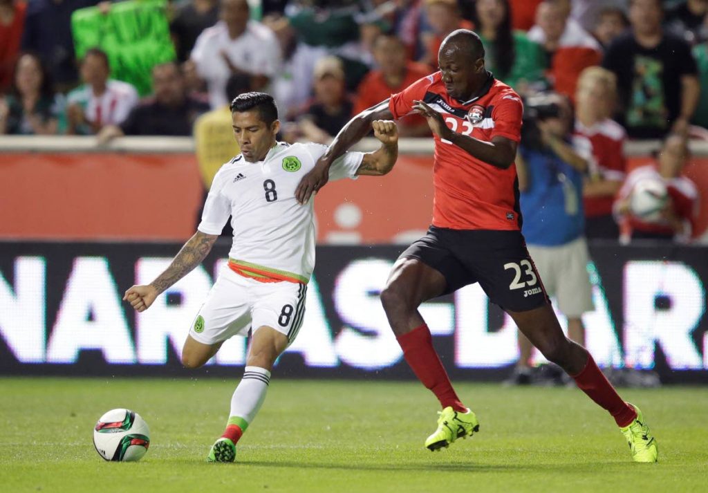 In this September 4,2015 file photo, Mexico midfielder Javier Aquino (8) passes the ball as TT defender 
Daneil Cyrus (23) defends during the first half during an international friendly, in Salt Lake City, USA. 
TT coach Dennis Lawrence named his squad to face Panama in a friendly on Tuesday.